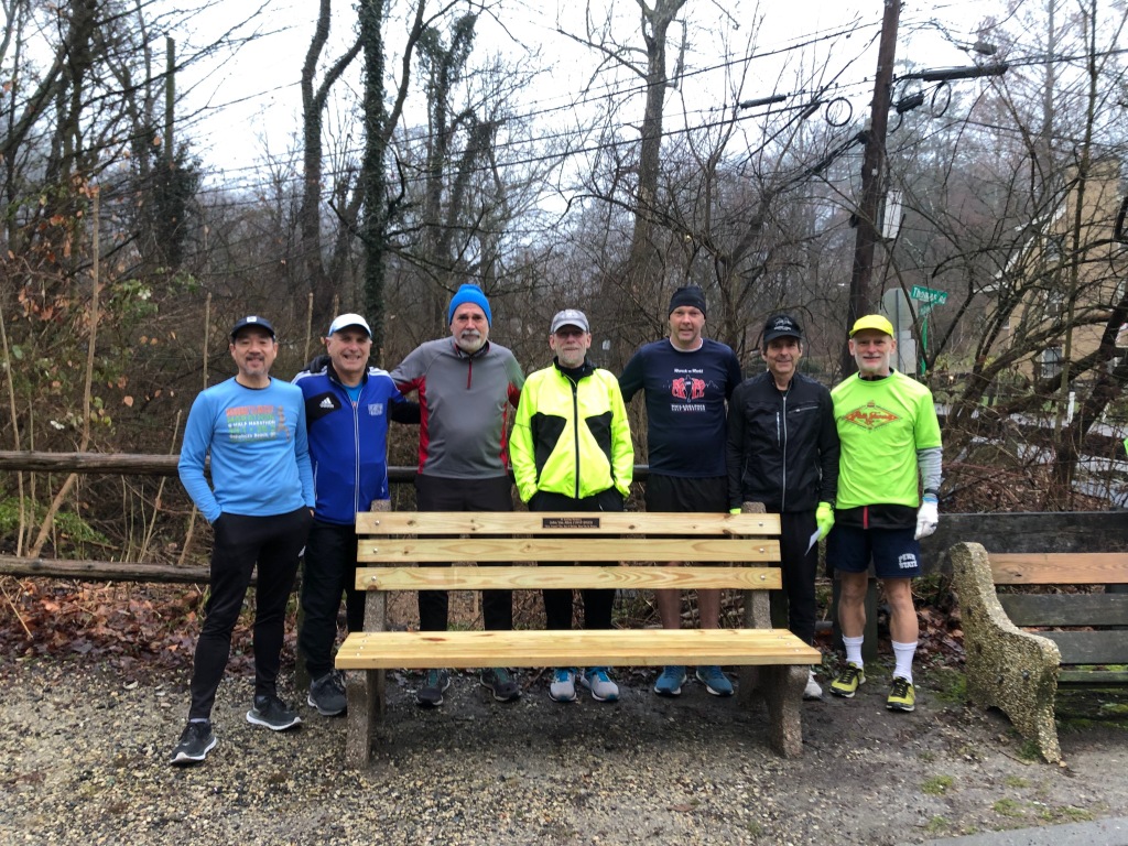 7 SRC runners in front of brand-new park bench.